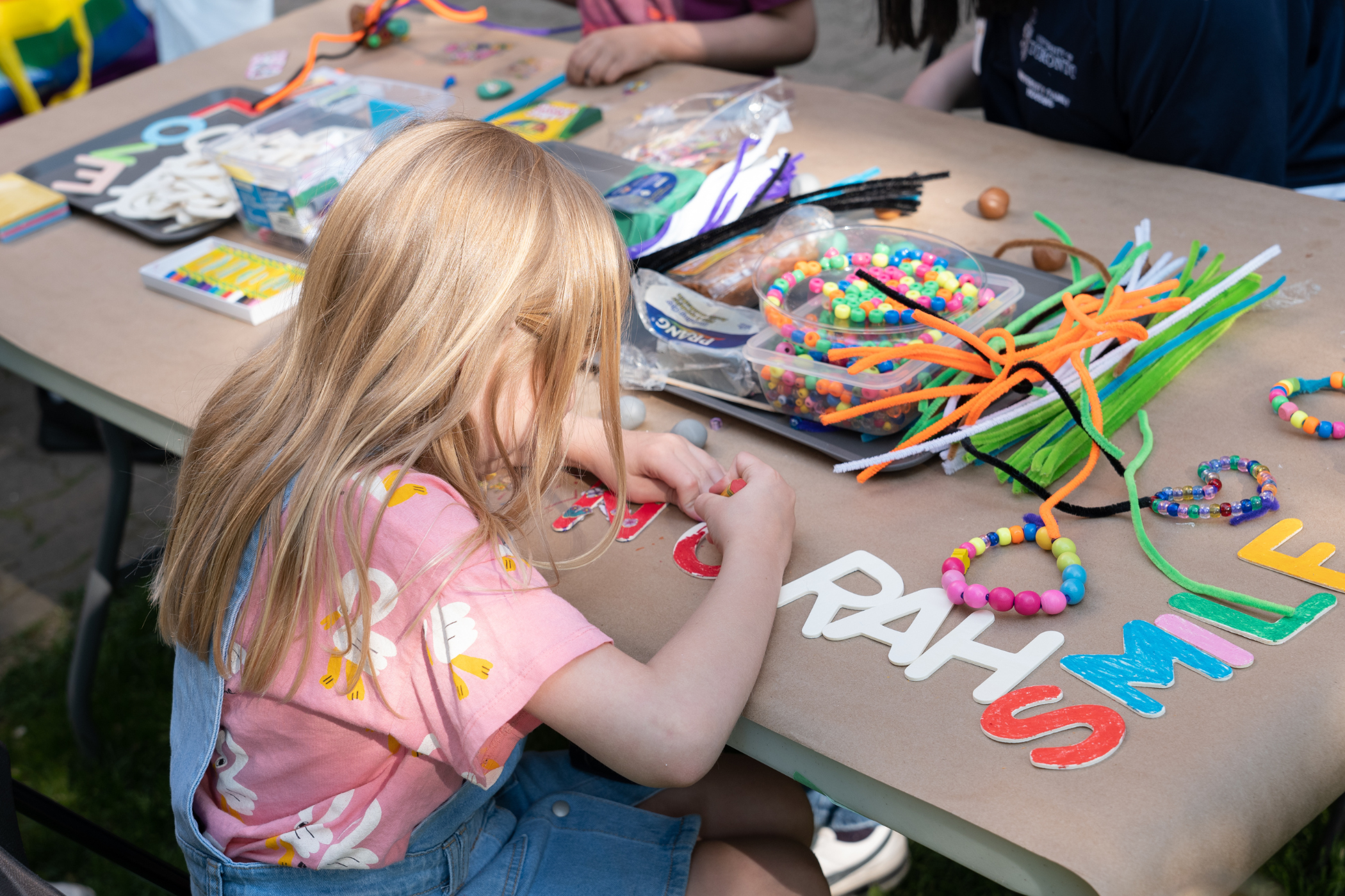 Young girl colours at craft table