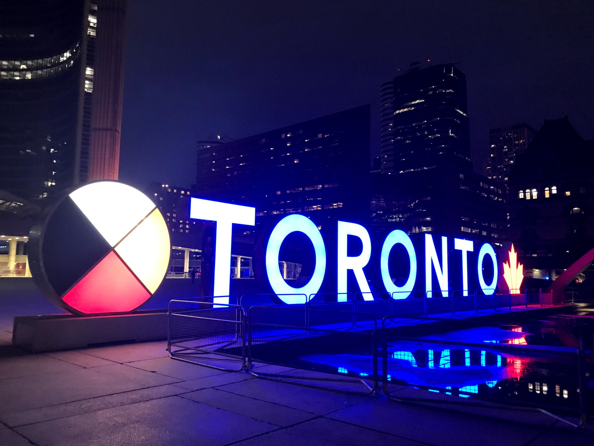 A large Toronto sign illuminated at night